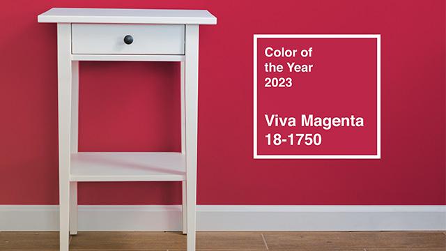 White wooden table against a magenta wall, Pantone Color of the Year 2023